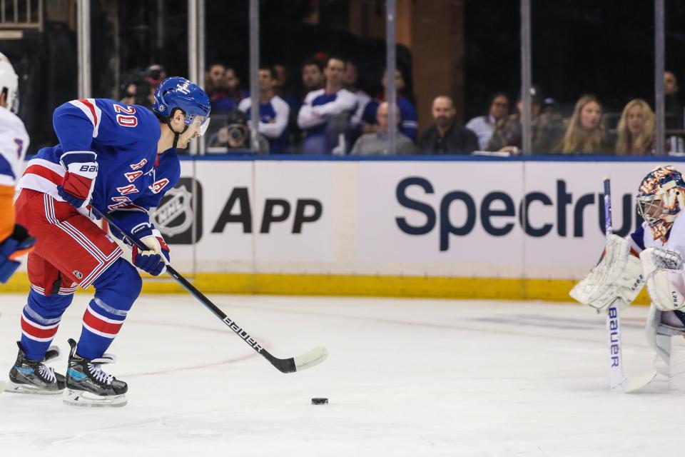Sep 26, 2023; New York, New York, USA; New York Rangers left wing Chris Kreider (20) attempts a shot on goal in the first period against the New York Islanders at Madison Square Garden.