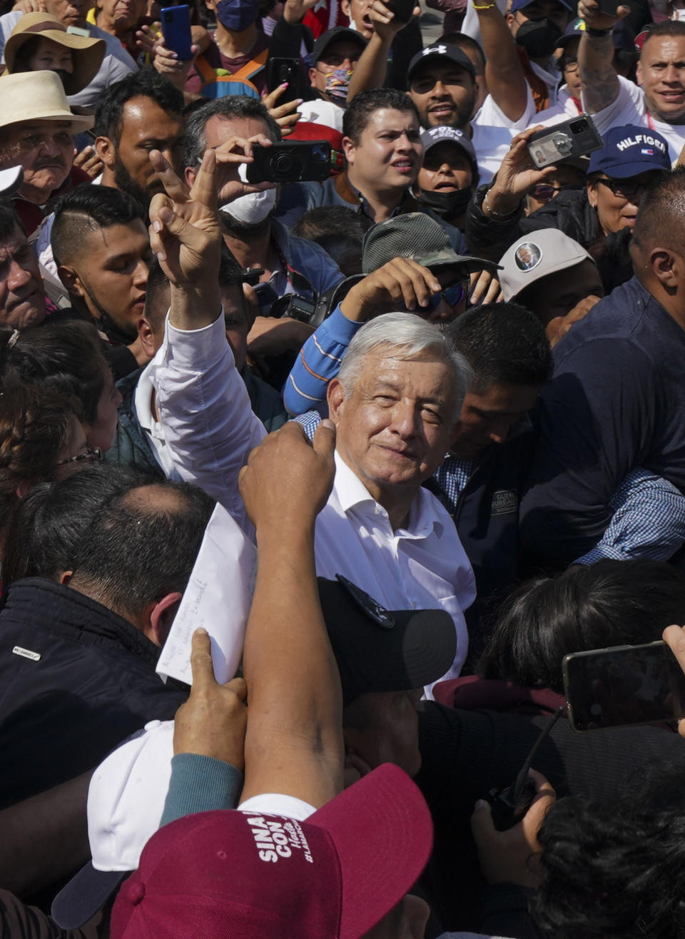 Mexican President Andrés Mexican President Andrés Manuel Lopez Obrador, right, makes the victory signal during a march in support of his administration, in Mexico City, Sunday, Nov. 27, 2022.(AP Photo/Fernando Llano)