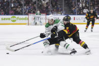 Vancouver Canucks' Conor Garland, right, checks Dallas Stars' Logan Stankoven during the first period of an NHL hockey game Thursday, March 28, 2024, in Vancouver, British Columbia. (Darryl Dyck/The Canadian Press via AP)