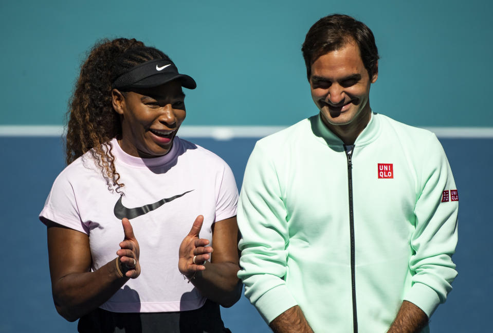 Serena Williams of the United States speaks to Roger Federer of Switzerland during the ribbon cutting ceremony on the new Stadium Court at the Hard Rock Stadium.