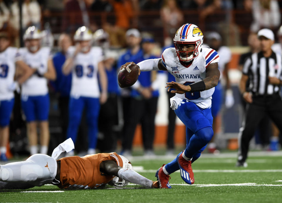 Jayhawks QB Jalon Daniels escapes from the pocket against Texas on Nov. 13, 2021, at Darrell K Royal-Texas Memorial Stadium in Austin. (Photo by John Rivera/Icon Sportswire via Getty Images)