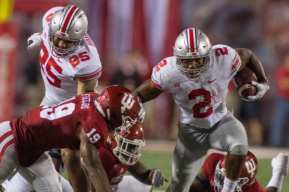 Aug 31, 2017; Bloomington, IN, USA; Ohio State Buckeyes running back J.K. Dobbins (2) stiff arms Indiana Hoosiers defensive back Tony Fields (19) in the second quarter of the game at Memorial Stadium. Mandatory Credit: Trevor Ruszkowski-USA TODAY Sports