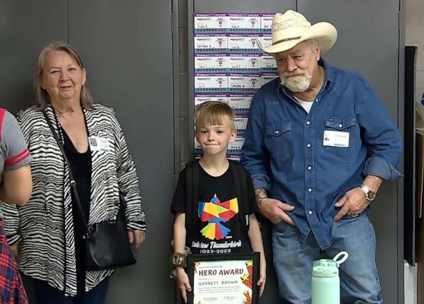 PHOTO: Garrett with his parents at an assembly at Lakeview Elementary School where he was presented with a 'hero award' for helping to save a choking classmate, in Norman, Okla. (KOCO-TV)