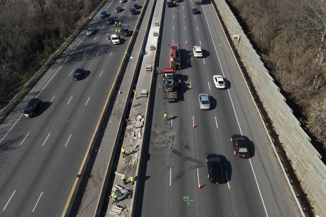 Emergency personnel work at the scene of a fatal crash along Interstate 695 on Wednesday, March 22, 2023, near Woodlawn, Md.