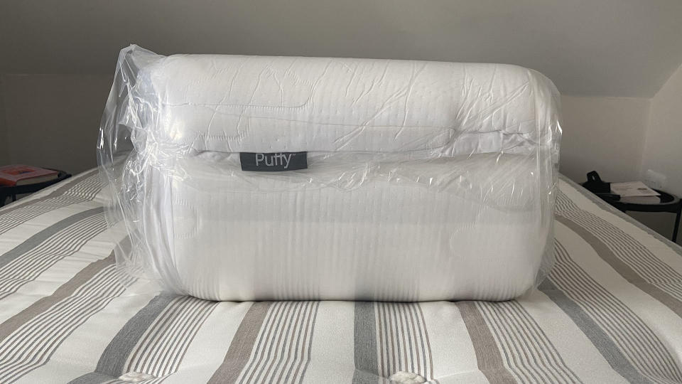 Puffy Deluxe Mattress Topper vacuum-packed and rolled on reviewer's bed