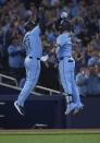 Toronto Blue Jays designated hitter Justin Turner, right, celebrates after his solo home run with third base coach Carlos Febles (51) while playing against the Kansas City Royals during third-inning baseball game action in Toronto, Monday, April 29, 2024. (Nathan Denette/The Canadian Press via AP)