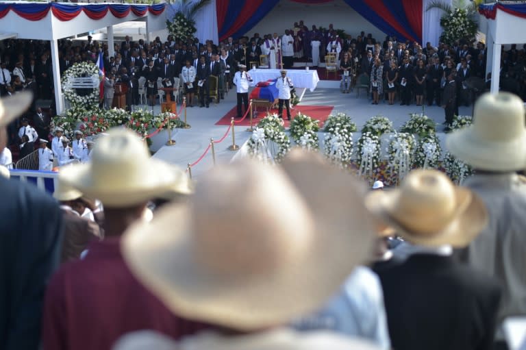 People attend the State Funeral for former Haitian president Rene Preval at the kioske Occide Jeanty, in Port-au-Prince, on March 11, 2017 Former Haitian President Rene Preval, who served two terms as the country's president, died on March 3 at age 74