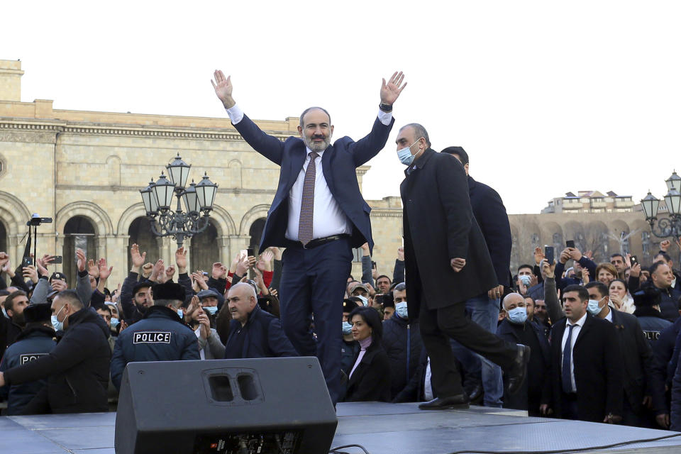 Armenian Prime Minister Nikol Pashinyan greets his supporters during a rally in the central in Yerevan, Armenia, Thursday, Feb. 25, 2021. Armenia's prime minister accused top military officers on Thursday of attempting a coup after they demanded he step down, adding fuel to months long protests calling for his resignation following the nation's defeat in a conflict with Azerbaijan over the Nagorno-Karabakh region. (Stepan Poghosyan/PHOTOLURE via AP)