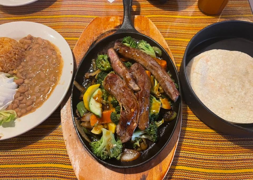 A grilled steak fajita with plenty of hearty vegetables, served with tortillas, beans and rice from El Meson in Freehold.