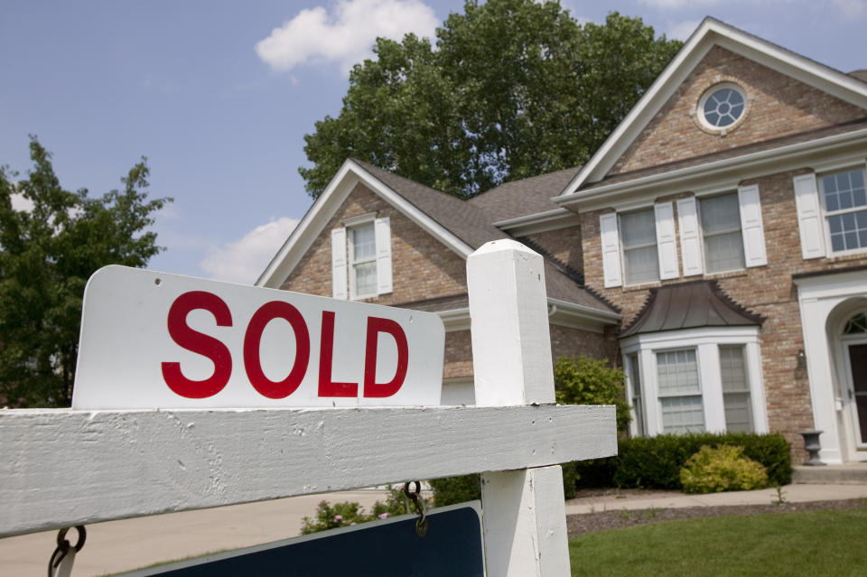 House with a SOLD sign in front.