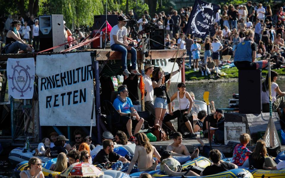 People attend a rave in boats of all sizes to give support to Berlin's world renowned dance clubs which are struggling due to coronavirus COVID-19 pandemic on the Landwehr canal on May 31, 2020 in Berlin's Kreuzberg district. (Photo by David GANNON / AFP) (Photo by DAVID GANNON/AFP via Getty Images) - DAVID GANNON/AFP