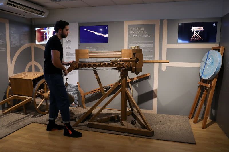 Exhibition Director Panagiotis Kotsonis uses the replica of an ancient weapon at the Kotsanas Museum of Ancient Greek Technology in Athens