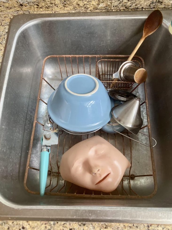 A mannequin face in a sink