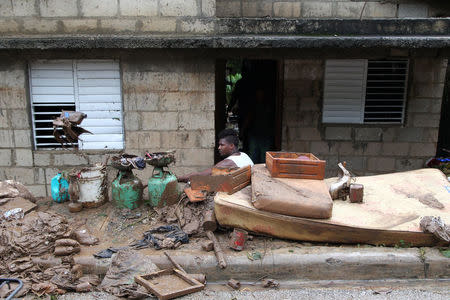 A man sweeps mud out of a house after an overflow of the Soco River, in the aftermath of Hurricane Maria, in El Seibo, Dominican Republic, September 22, 2017. REUTERS/Ricardo Rojas