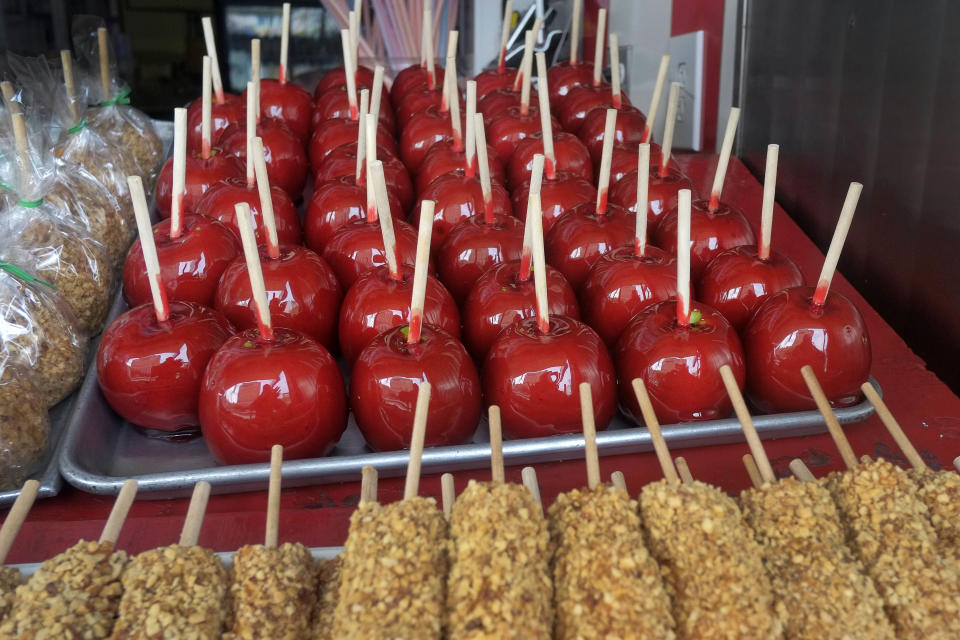 FILE - In this file photo of May 23, 2013, a tray of candy apples is displayed at Williams Candy at Coney Island in the Brooklyn borough of New York.Eight months after Superstorm Sandy hit New York City, Coney Island’s rides, eateries and beach are getting plenty of visitors, and there are even a few new attractions like a carousel and a store for fans of the Nets basektball team. (AP Photo/Mark Lennihan, File)