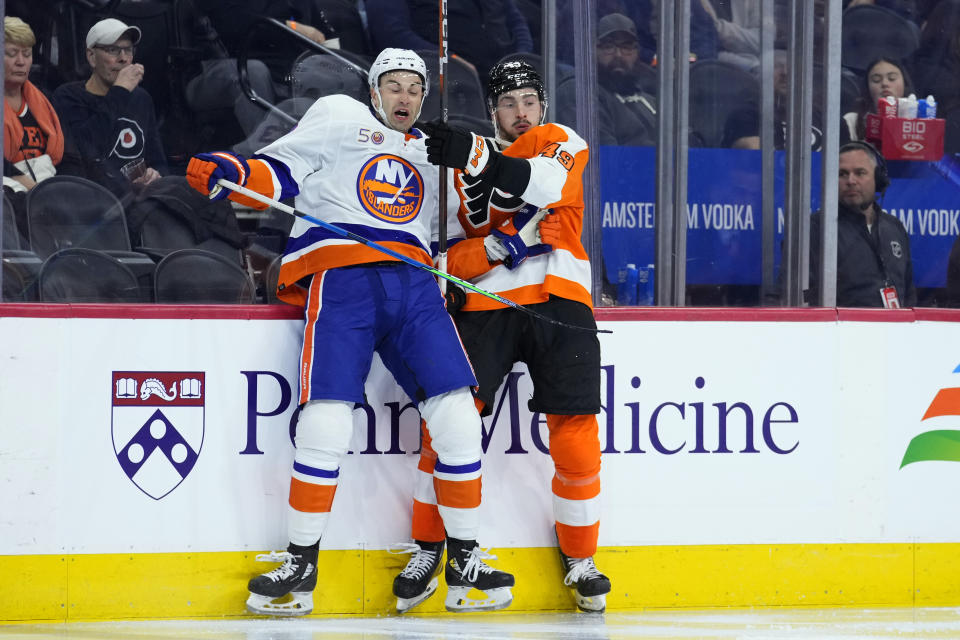 New York Islanders' Adam Pelech, left, and Philadelphia Flyers' Noah Cates collide during the second period of an NHL hockey game, Monday, Feb. 6, 2023, in Philadelphia. (AP Photo/Matt Slocum)