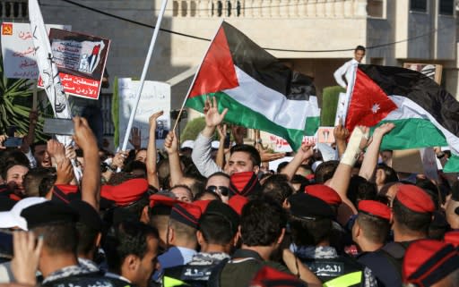 Protesters wave Palestinian and Jordanian flags outside the US embassy in Amman as they chant slogans against the US-led Bahrain conference on the Middle East