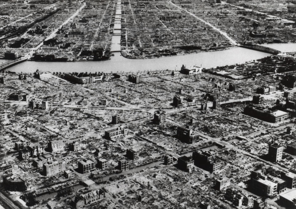 FILE - This aerial photo taken in March 9, 1945 shows the industrial section of Tokyo along the Sumida River. The nuclear bombs dropped by the United States on Hiroshima and Nagasaki in Aug. 1945 secured Japan's surrender and ended World War II. In Japan, war orphans were punished for surviving. They were bullied. They were called trash, sometimes rounded up by police and put in cages. Some were sent to institutions or sold for labor. They were targets of abuse and discrimination. Now, 75 years after the war's end, some are revealing their untold stories of recovery and pain, underscoring Japan’s failure to help its own people. (AP Photo, File)