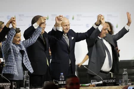 From L-R, Christiana Figueres, Executive Secretary of the UN Framework Convention on Climate Change, United Nations Secretary-General Ban Ki-moon, French Foreign Affairs Minister Laurent Fabius, President-designate of COP21 and French President Francois Hollande react during the final plenary session at the World Climate Change Conference 2015 (COP21) at Le Bourget, near Paris, France, December 12, 2015. REUTERS/Stephane Mahe