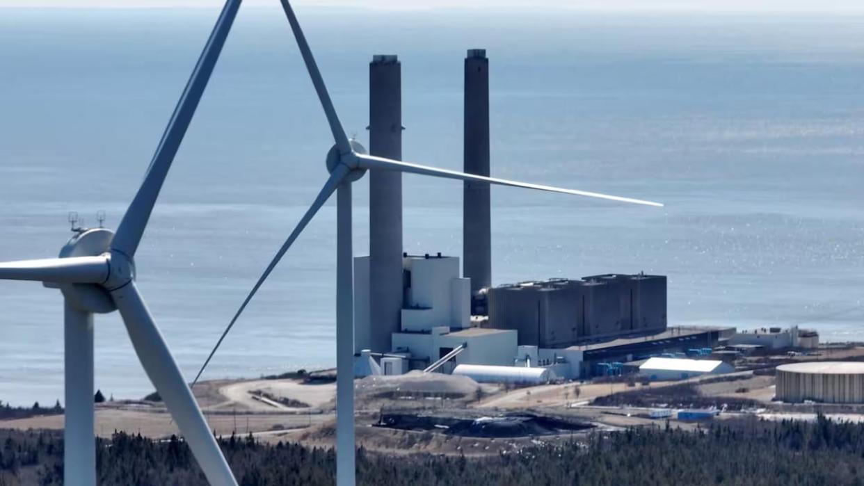 The Burchill wind farm sits by the Bay of Fundy at the western edge of Saint John near the giant smokestacks of N.B. Power's Coleson Cove oil-burning generating station.  (Roger Cosman/CBC - image credit)