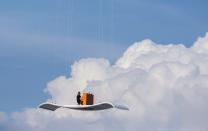 RNPS - REUTERS NEWS PICTURE SERVICE - PICTURES OF THE YEAR 2014 - ODDLY German pianist Stefan Aaron plays an orange piano on a "flying carpet" platform suspended from a helicopter, over the Munich airport in this July 23, 2014 file photo. REUTERS/Lukas Barth/Files (GERMANY - Tags: SOCIETY TPX IMAGES OF THE DAY)