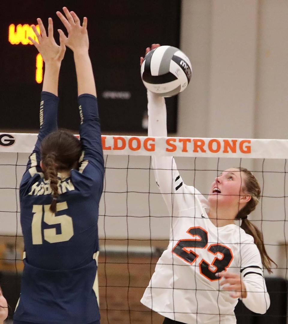 Kylie Gorsuch, right, of Green slams the ball over for a point past Molly Kennedy of Hoban during the second set of their match at Green High School Wednesday night. Hoban  won 3 sets to 0. 