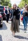 <p>Palermo wears a gold and black metallic skirt, black top, and blazer. (Photo: Getty) </p>