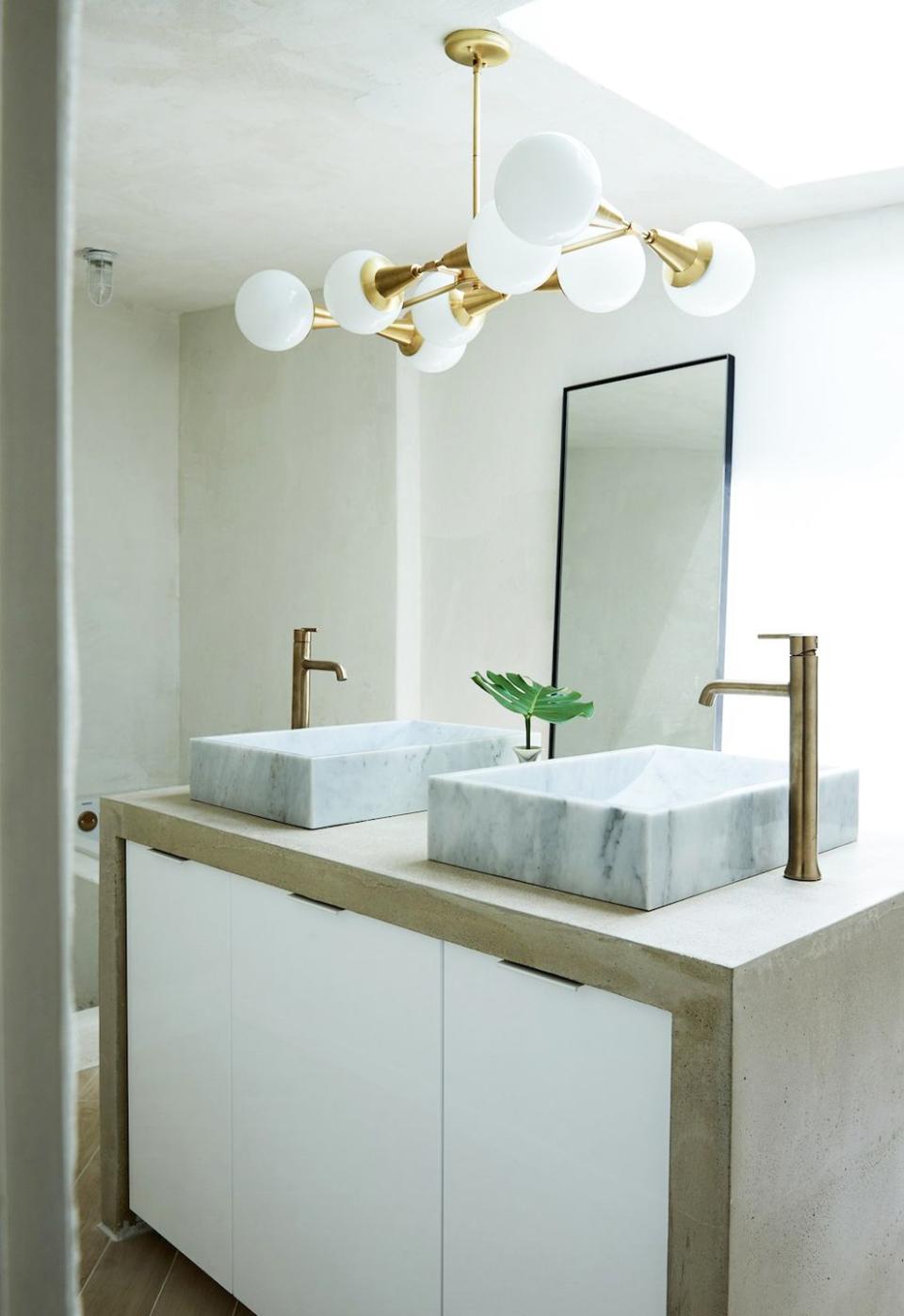 <p>You've heard of kitchen islands but have you heard of bathroom sink islands? Designer Leanne Ford introduced intrigue to this space by floating the sink vanities instead of keep them against the wall. </p>