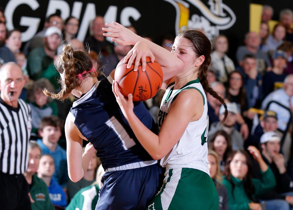 Portland St. Patrick's Lydia Meredith, right, and Fowler's Emma Riley battle for a rebound, Friday, March 4, 2022, at Lansing Christian High School.