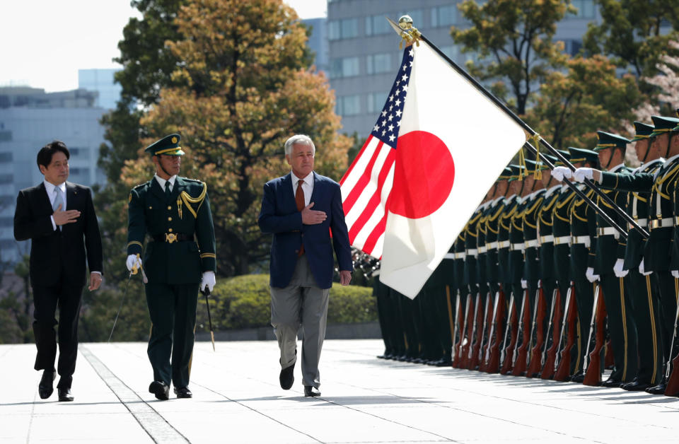 U.S. Secretary of Defense Chuck Hagel, right, reviews honor guards accompanied by Japanese Defense Minister Itsunori Onodera, left, at the Japanese Ministry of Defense headquarters Sunday, April 6, 2014 in Tokyo, Japan. Secretary Hagel is visiting Japan, China and Mongolia, his fourth trip to Asian nations since taking office. (AP Photo/Alex Wong, Pool)