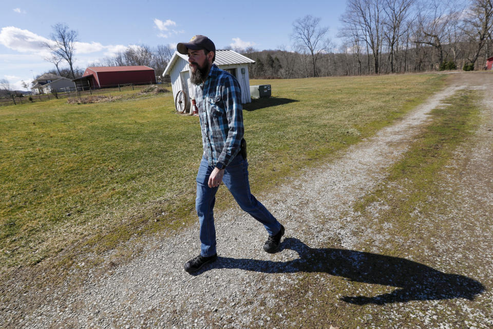 In this Friday, March 13, 2020, photo, Nic Talbott walks from his house to his grandmother's in Lisbon, Ohio. Talbott is a plaintiff in one of four lawsuits filed in federal courts challenging a Trump administration policy barring transgender Americans from enlisting in the military. (AP Photo/Keith Srakocic)