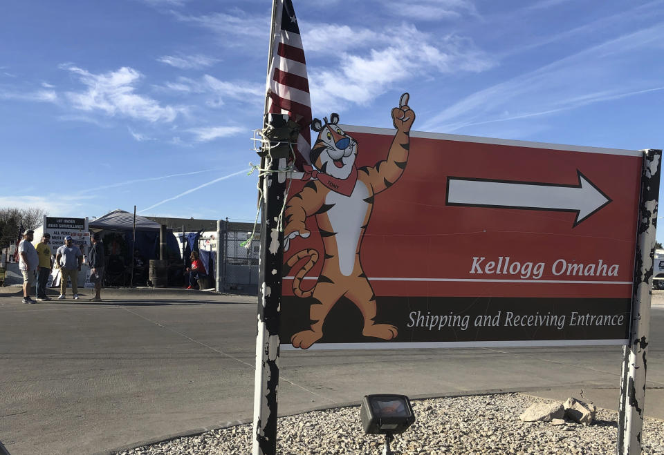 Striking Kellogg's workers stand outside the company's cereal plant in Omaha, Neb., Thursday, Dec. 2, 2021. The company and the union announced a tentative agreement Thursday that could end the strike that began Oct. 5. (AP Photo/ Josh Funk)