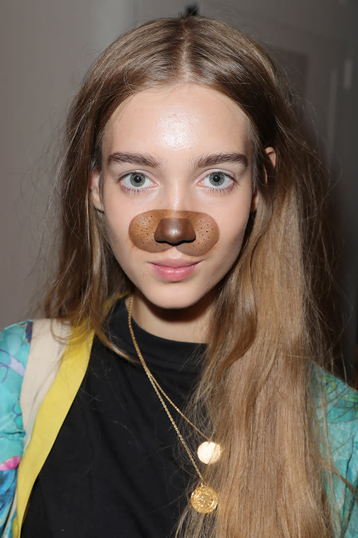 A Desigual model wears Snapchat filter makeup backstage before the NYFW show. (Photo: Getty)