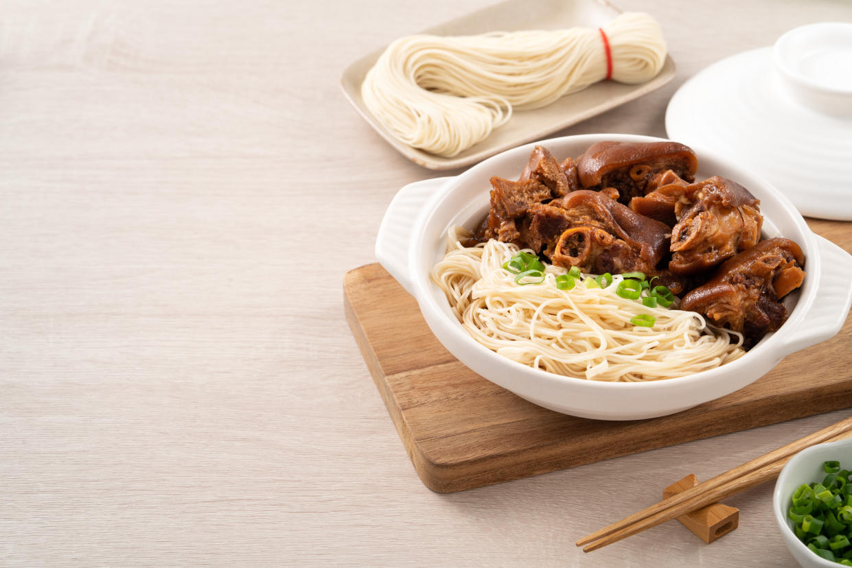 Taiwanese traditional food pork knuckle with vermicelli on wooden table background.