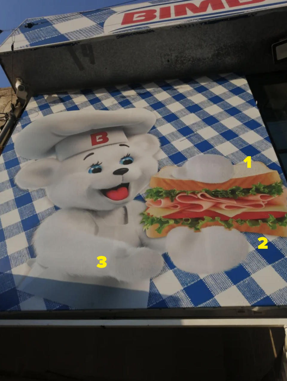 Bimbo the bear holding a sandwich