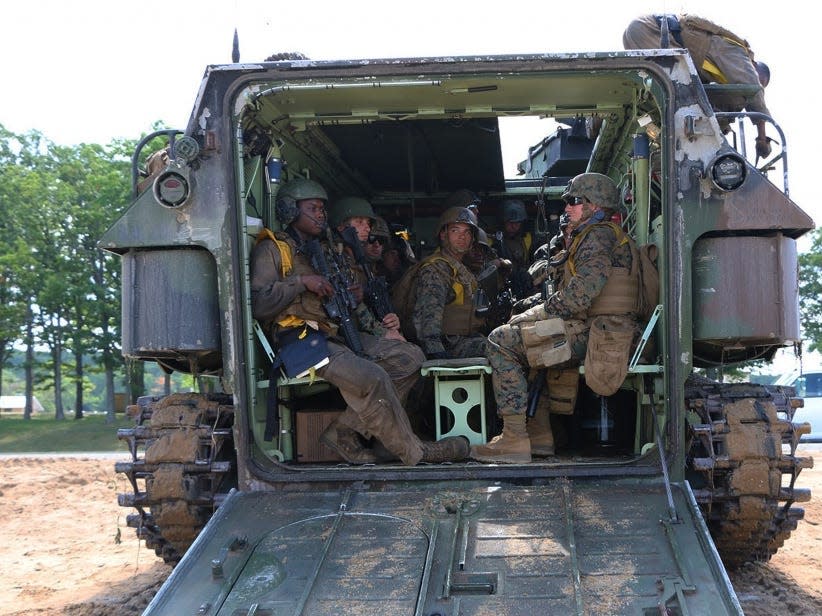 Marines aboard amphibious assault vehicle prepare for an amphibious assault.