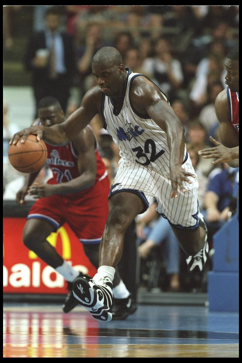 Shaquille O'Neal of the Orlando Magic moves the ball against the Washington Bullets during a game played at the Orlando Arena in Orlando, Florida on April 16, 1996. (Allsport)