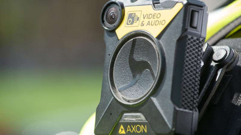 Close-up of AXON body camera affixed to a police officer's uniform.