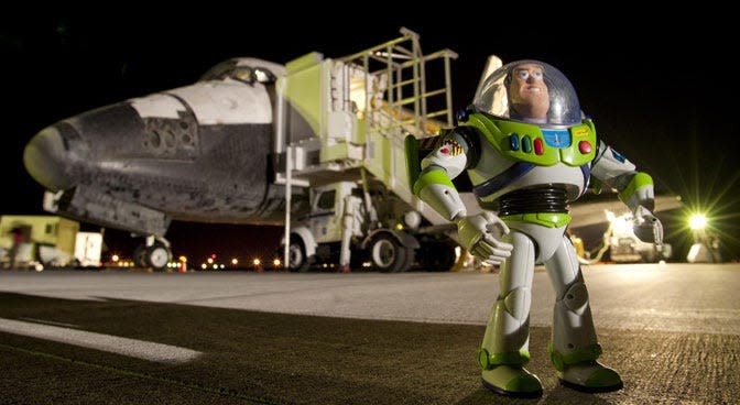 The Buzz Lightyear toy in front of Space Shuttle Discovery in 2008