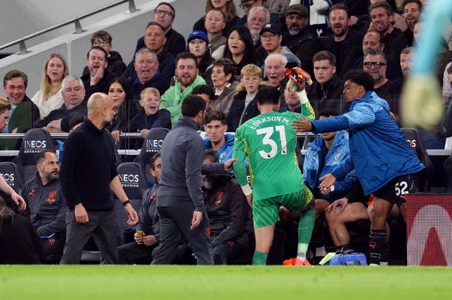 Ederson, centre, throws his gloves down after being substituted