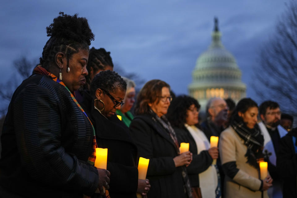 The Rev. Dr. Cassandra Gould, left, gathers with other Christian leaders for a prayer vigil to mark the second year anniversary of the violent insurrection by supporters of then-President Donald Trump, on Capitol Hill in Washington, Friday, Jan. 6, 2023. (AP Photo/Matt Rourke)