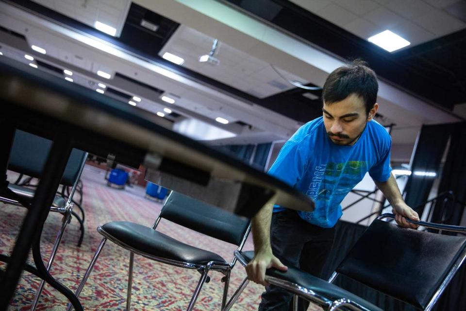 Joseph Sanchez, 18, sets up chairs in preparation for an upcoming event on Tuesday, Nov. 14, 2023, at the Gateway Convention Center in Collinsville, Ill. Sanchez is a senior at Collinsville High School and a part of an apprenticeship program for students with disabilities. Tristen Rouse/Tristen Rouse