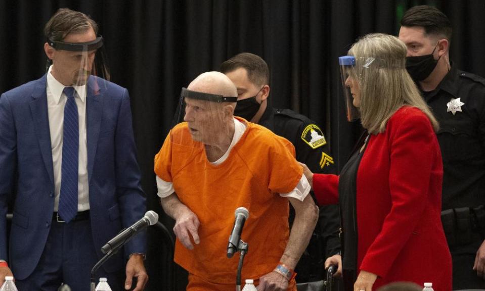 Joseph James DeAngelo, center, charged with being the Golden State Killer, is helped up by his attorney, Diane Howard, in court on 29 June.