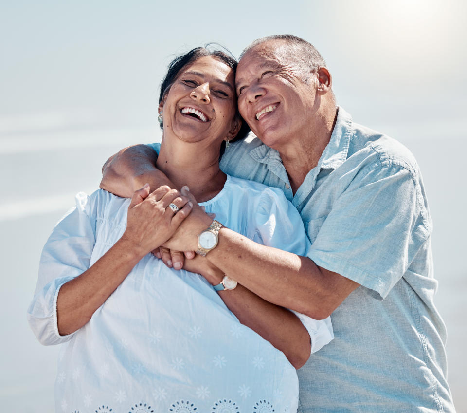 Retirement couple, laughing and hug in the sunshine (Getty) 