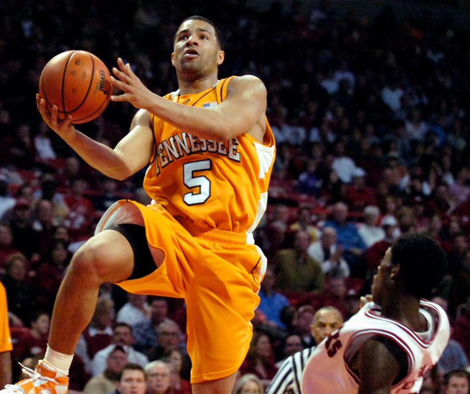 Tennessee's Chris Lofton drives for a layup for two of his 31 points as Arkansas' Patrick Beverley, right, falls back after contact during the second half of a college basketball game that Tennessee won 83-72 in Fayetteville, Ark., Saturday, Feb. 24, 2007.