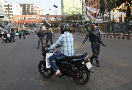 A police officer gestures to stop a motorbike for security check ahead of the 11th general election in Dhaka, Bangladesh, December 28, 2018. REUTERS/Mohammad Ponir Hossain
