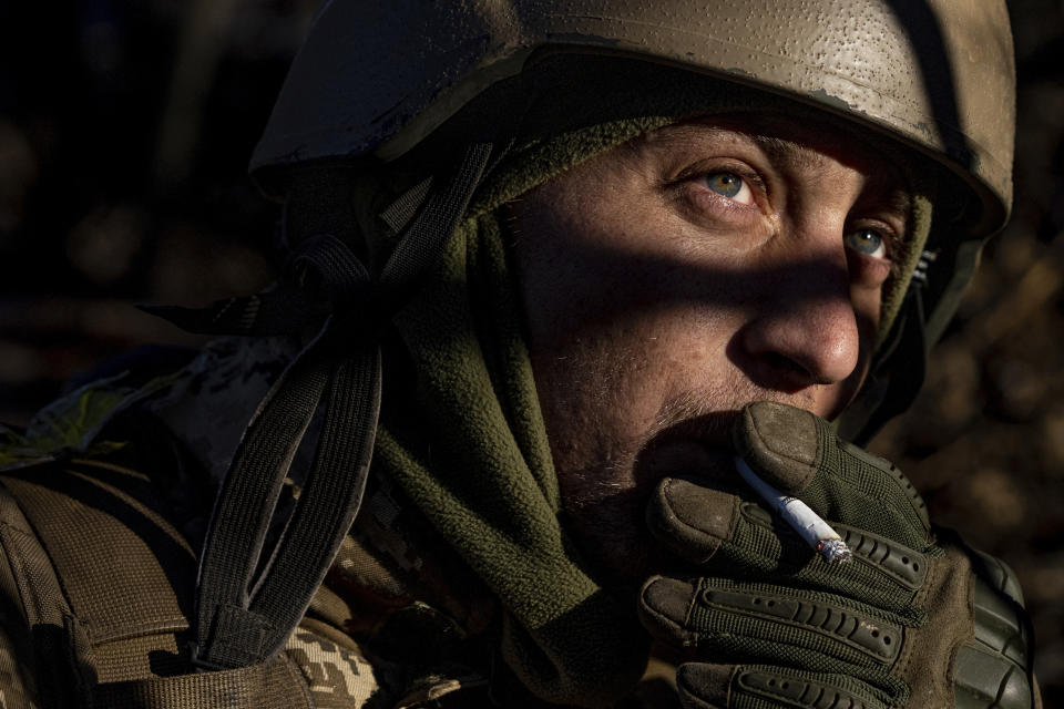 A Ukrainian serviceman smokes a cigarette at his position at the frontline near Bakhmut, Donetsk region, Ukraine, Wednesday, Jan. 11, 2023. (AP Photo/Evgeniy Maloletka)