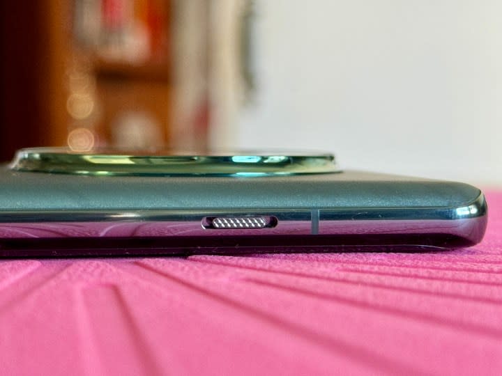 OnePlus 12 in Flowy Emerald showing alert slider on frame.