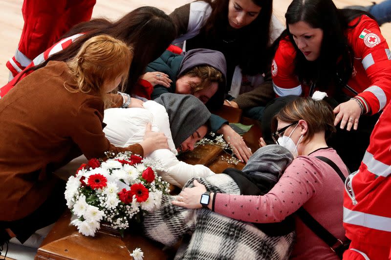 FILE PHOTO: Mourners react near coffins of victims who died in a migrant shipwreck, in Crotone