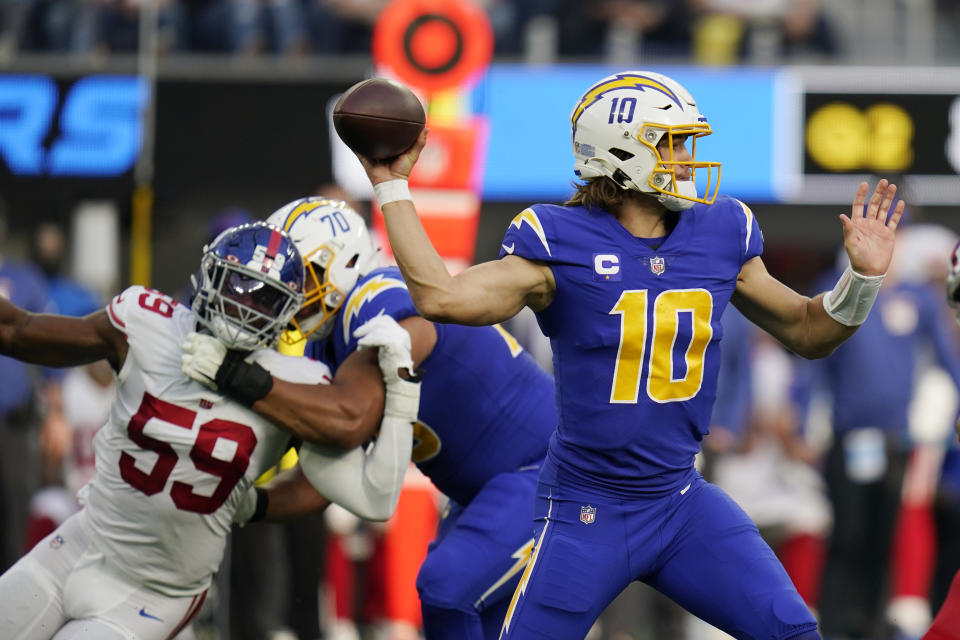 Los Angeles Chargers quarterback Justin Herbert throws against the New York Giants during the first half of an NFL football game Sunday, Dec. 12, 2021, in Inglewood, Calif. (AP Photo/Gregory Bull)